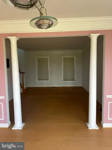 an empty room with windows and ceiling fan