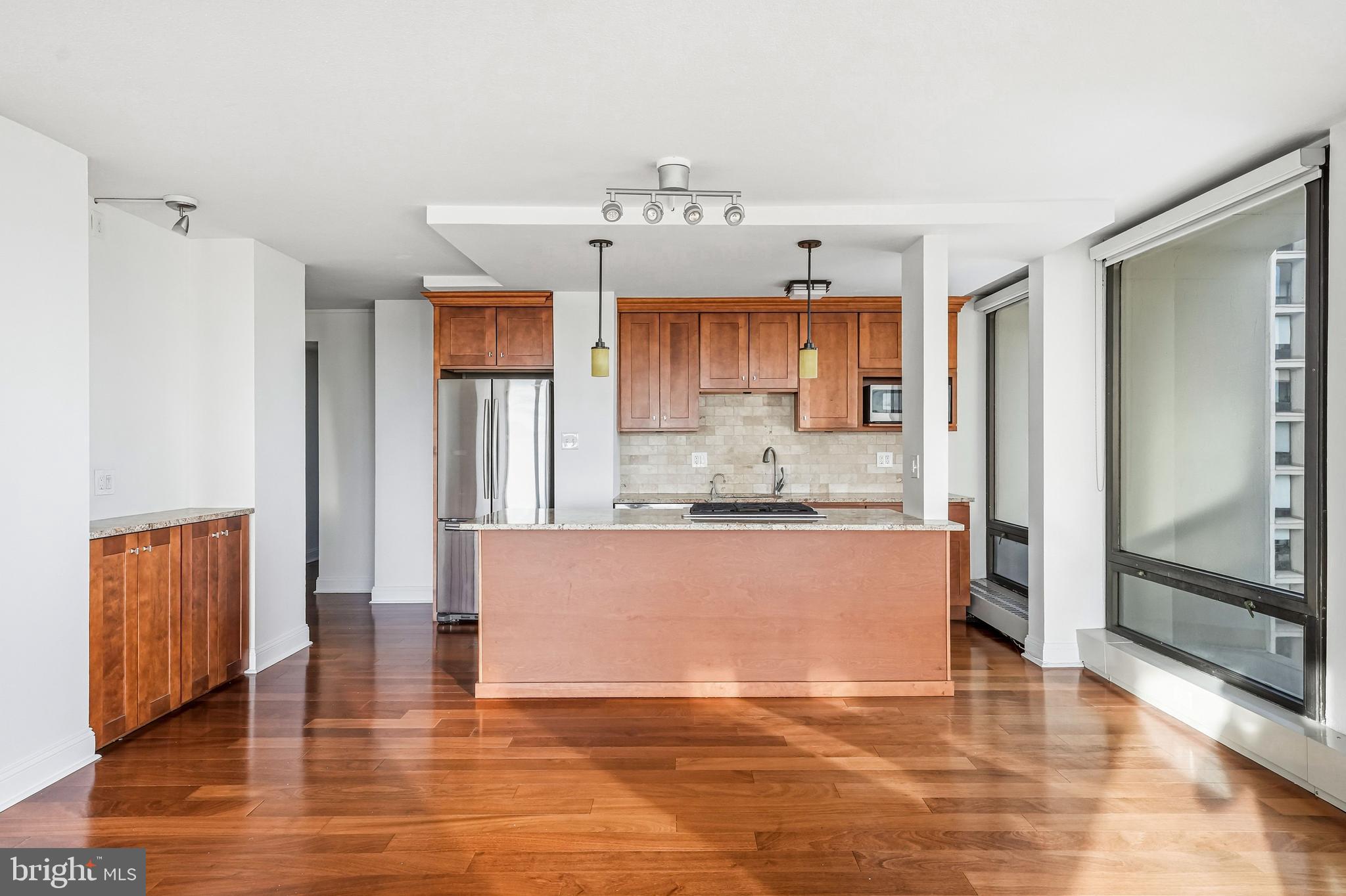 210 Locust Street, Unit 7BW Philadelphia, PA 19106 - Photo 11 of 34 a view of kitchen with granite countertop cabinets and refrigerator