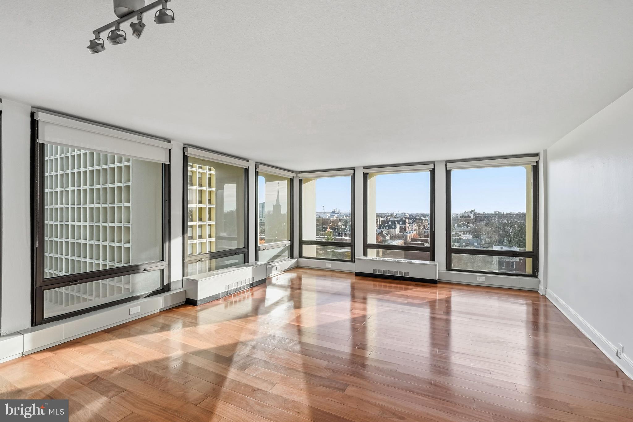 210 Locust Street, Unit 7BW Philadelphia, PA 19106 - Photo 3 of 34 a view of an empty room with wooden floor and a fireplace