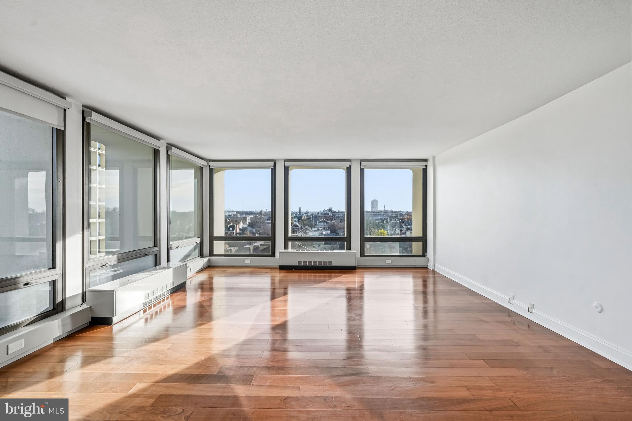 210 Locust Street, Unit 7BW Philadelphia, PA 19106 - Photo 4 of 34 a view of an empty room with wooden floor and a window