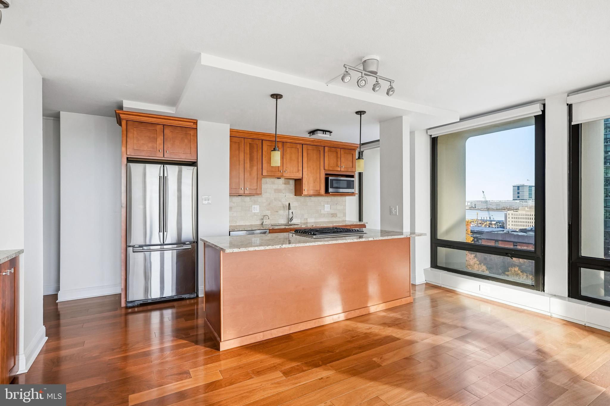 210 Locust Street, Unit 7BW Philadelphia, PA 19106 - Photo 10 of 34 a kitchen with stainless steel appliances granite countertop a refrigerator and a stove top oven