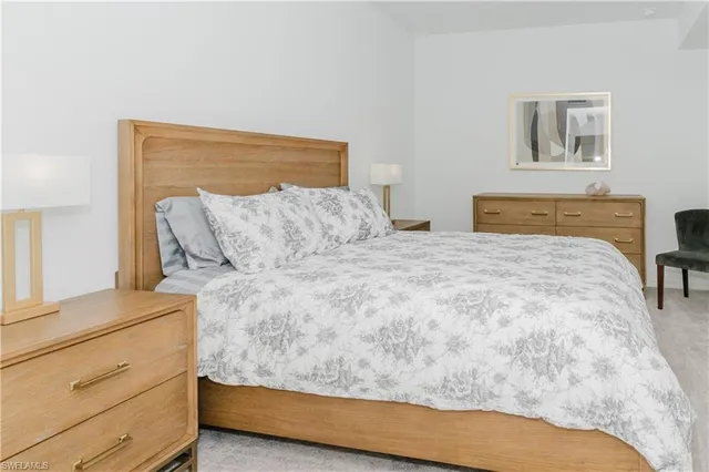 a bedroom with a bed and painting on the wall