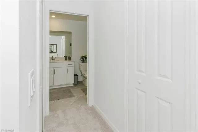 a view of a bathroom from the hallway with toilet