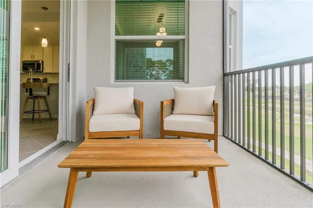 a view of a bedroom with furniture and windows