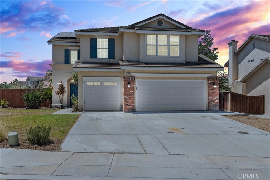 20083 Aptos Street Riverside, CA 92508 - Photo 1 of 1 a front view of a house with a garden and garage