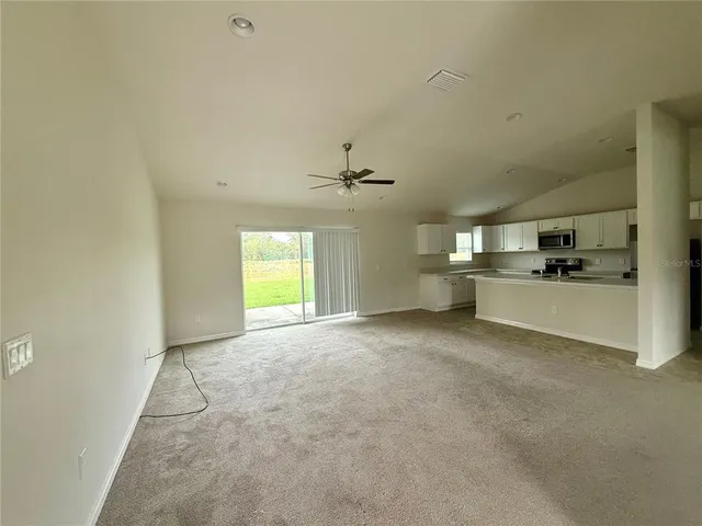 a view of a kitchen with a sink and a window