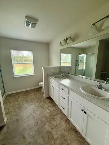 a bathroom with a granite countertop sink a mirror and a