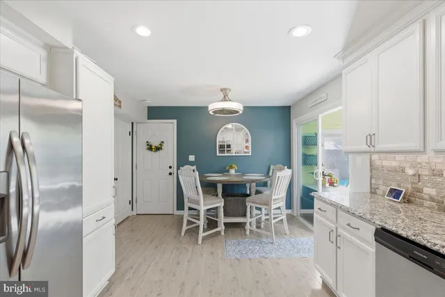 a view of a kitchen with dining table and chairs