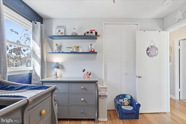 a bedroom with bed and a chandelier
