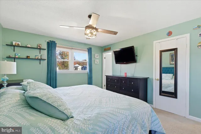 a bedroom with a bed and a dresser