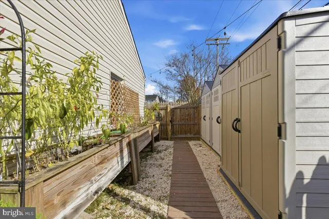 a view of a chair and table in backyard of the house
