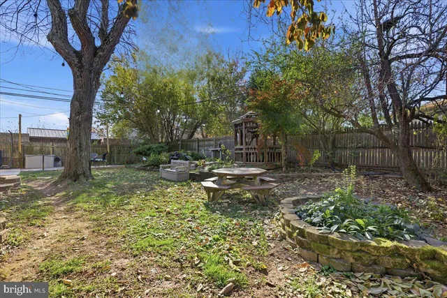 a view of a garage with a table and chairs under an umbrella