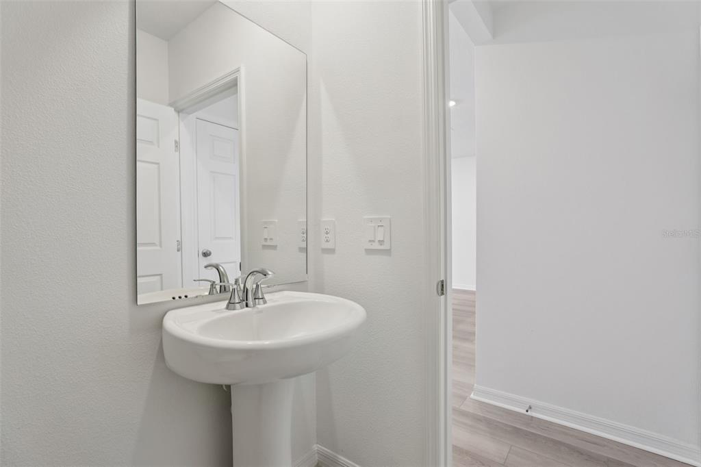 4264 Ranch House Road St. Cloud, FL 34772 - Photo 34 of 74 a bathroom with a sink and a mirror