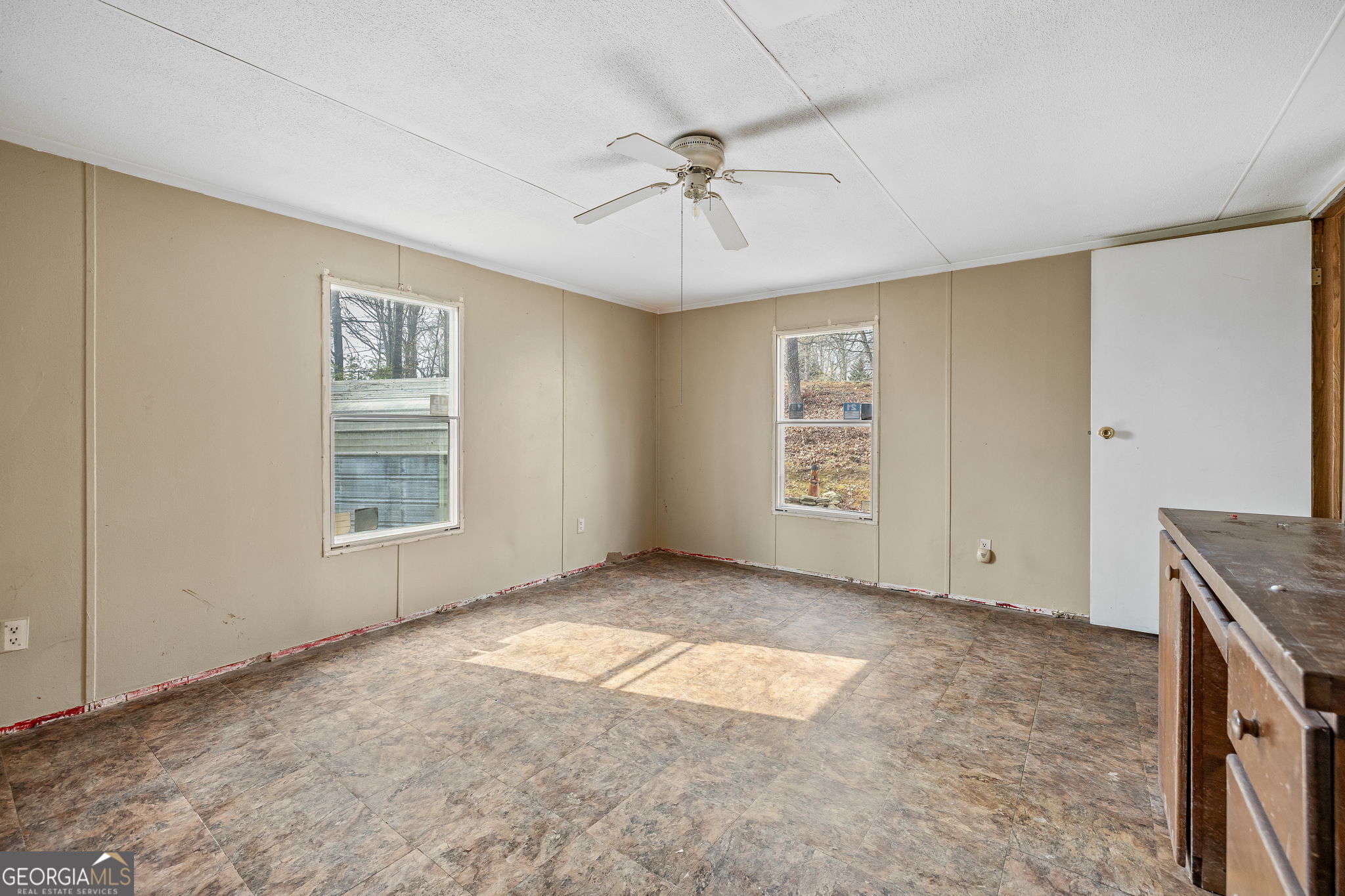 401 Otis Brown Road Baldwin, GA 30511 - Photo 16 of 23 an empty room with windows and fan