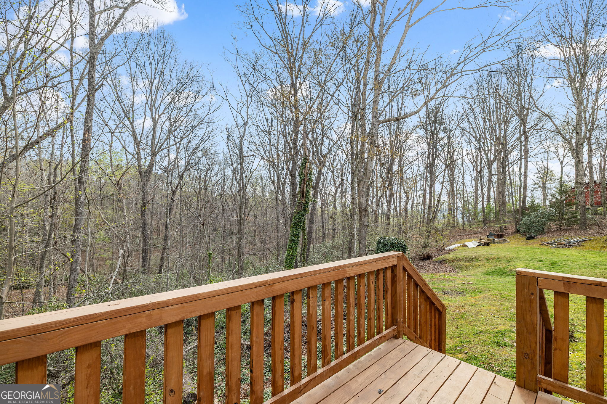 401 Otis Brown Road Baldwin, GA 30511 - Photo 20 of 23 a balcony with wooden floor and trees in the back