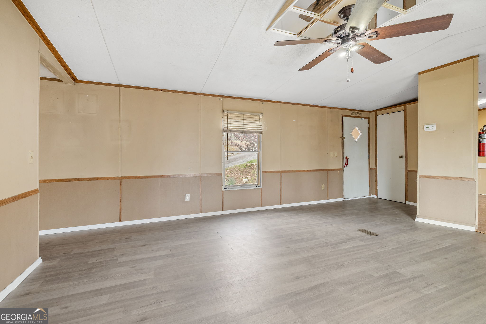401 Otis Brown Road Baldwin, GA 30511 - Photo 5 of 23 wooden floor in an empty room with a window
