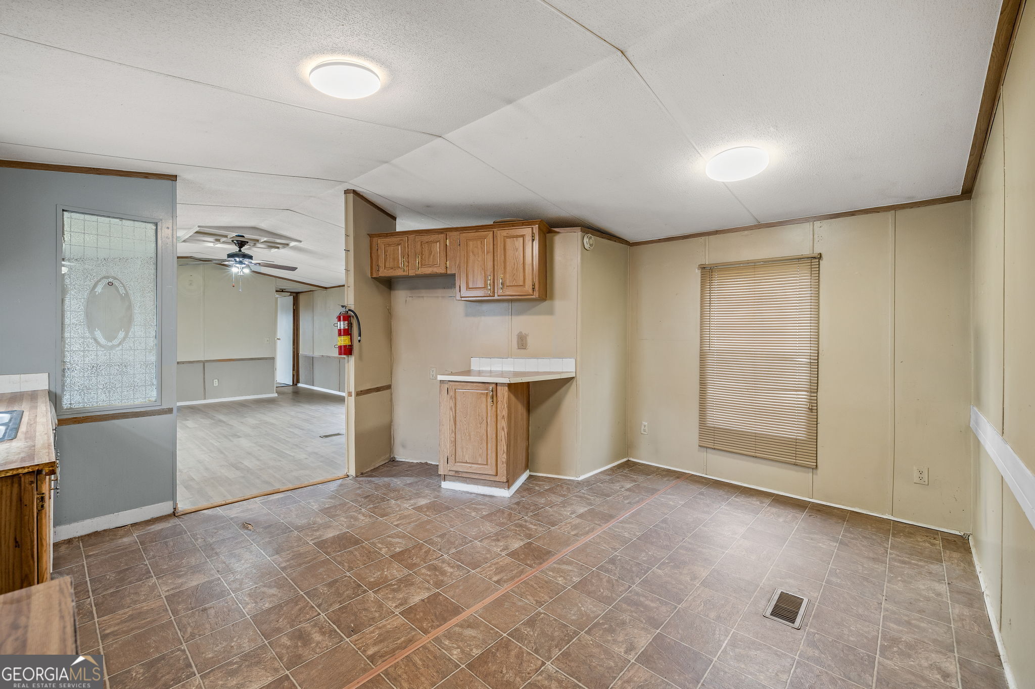 401 Otis Brown Road Baldwin, GA 30511 - Photo 7 of 23 a view of a kitchen with a sink and a refrigerator in it