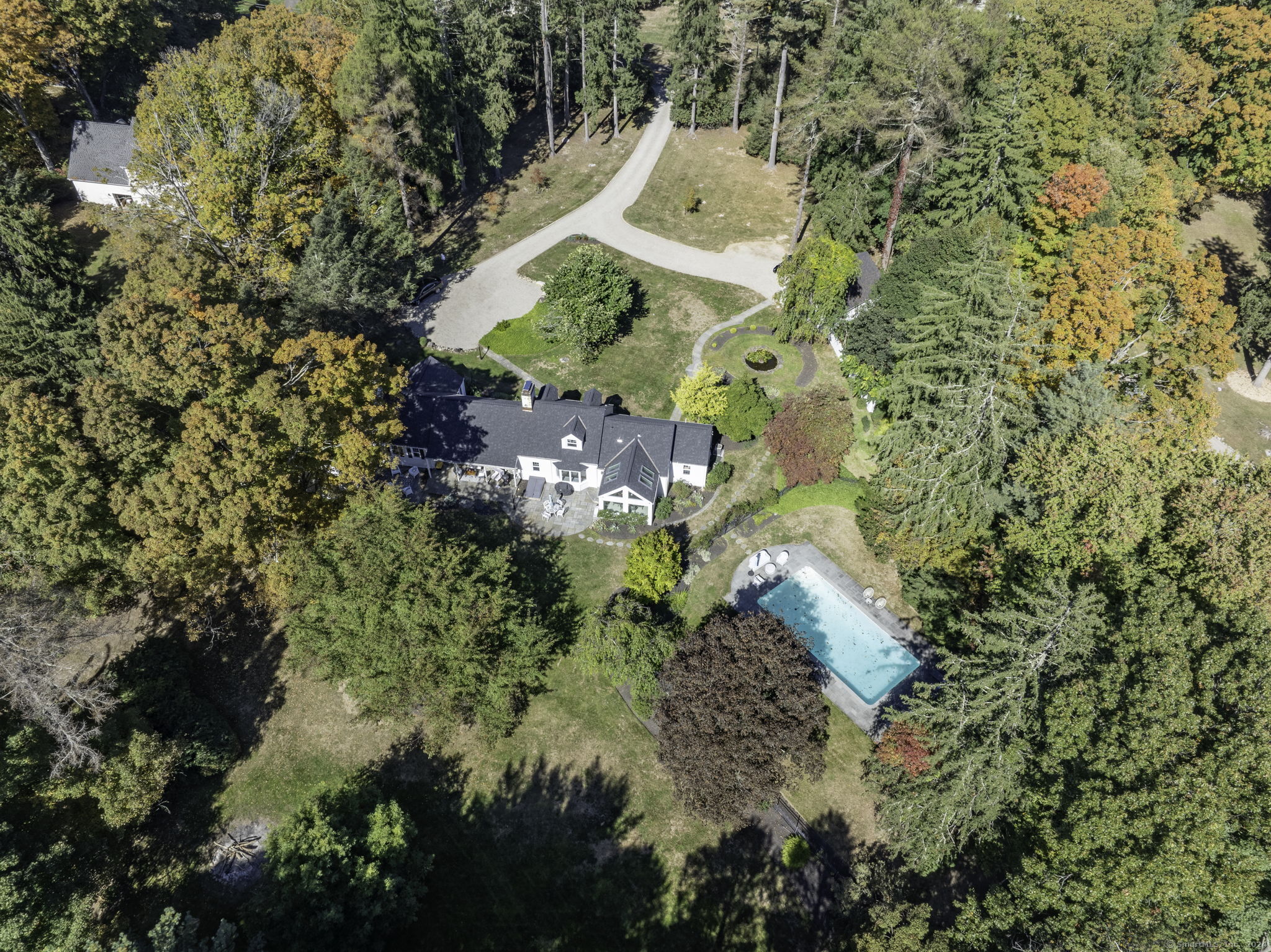 592 Haviland Road Stamford, CT 06903 - Photo 1 of 1 a aerial view of a house with a yard and large trees