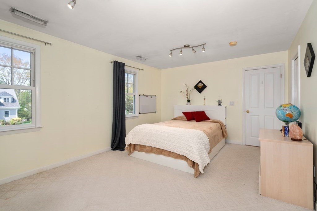 16 Ludwig Road, Unit 16 Needham, MA 02494 - Photo 17 of 33 a bed room with a bed and a painting on the wall