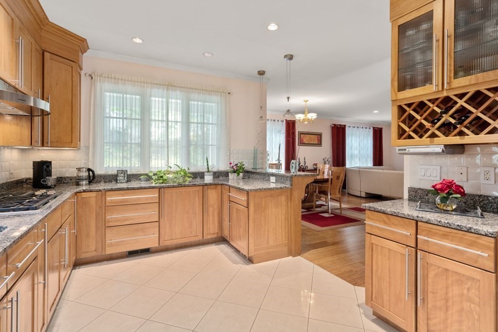 16 Ludwig Road, Unit 16 Needham, MA 02494 - Photo 3 of 33 a kitchen that has a lot of cabinets in it and wooden floors