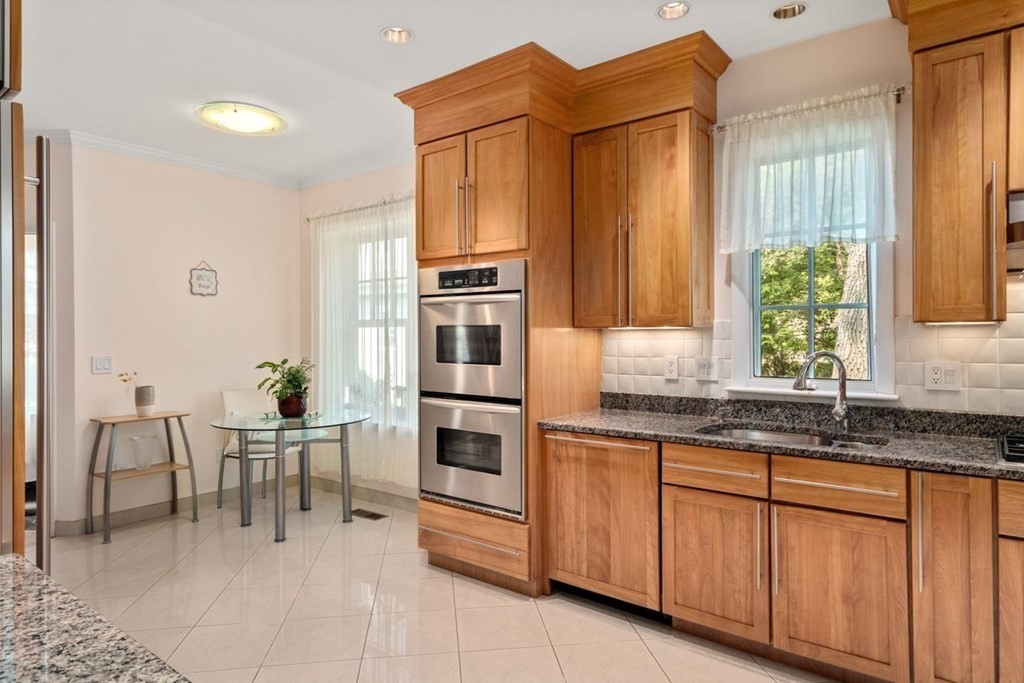 16 Ludwig Road, Unit 16 Needham, MA 02494 - Photo 7 of 33 a kitchen with granite countertop cabinets and chairs