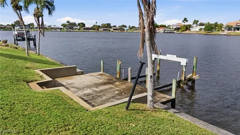a front view of a house with a yard and a garden