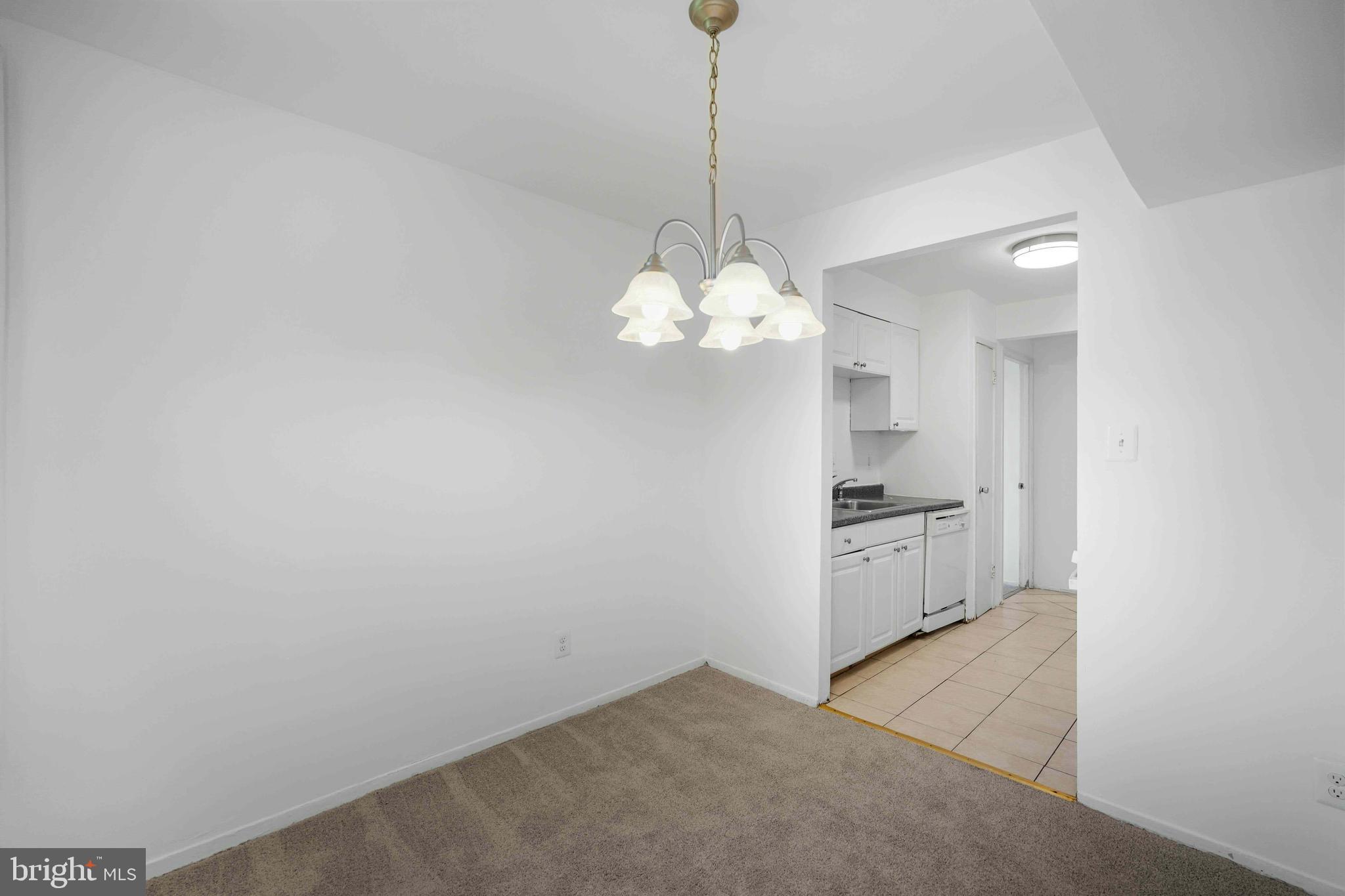 106 Duvall Lane, Unit 43 Gaithersburg, MD 20877 - Photo 12 of 38 a view of a kitchen with a sink and a chandelier