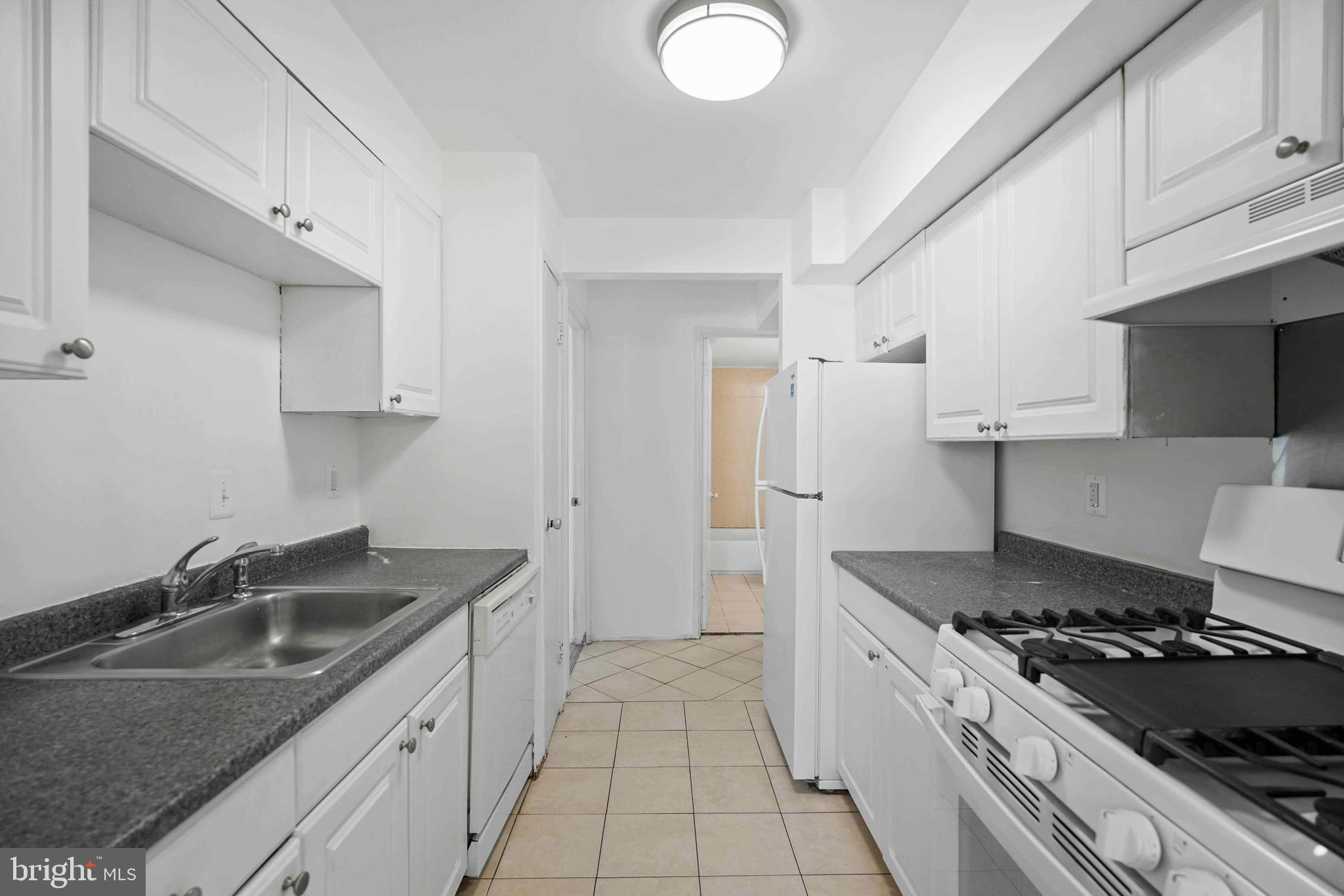 106 Duvall Lane, Unit 43 Gaithersburg, MD 20877 - Photo 14 of 38 a kitchen that has a sink and a stove