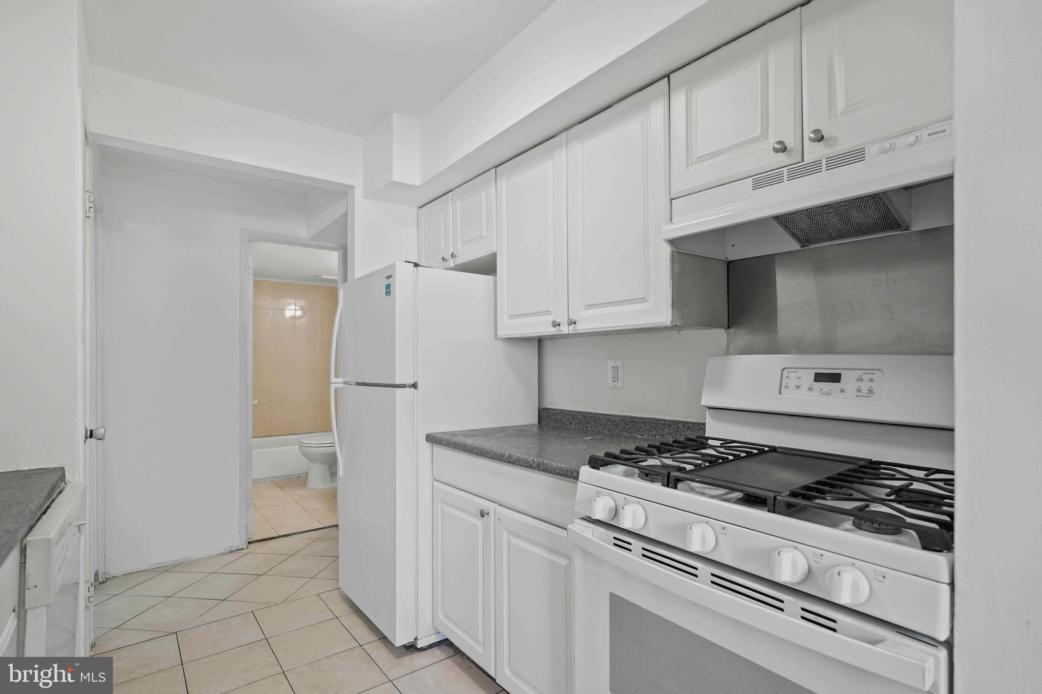 106 Duvall Lane, Unit 43 Gaithersburg, MD 20877 - Photo 15 of 38 a kitchen with white cabinets and appliances