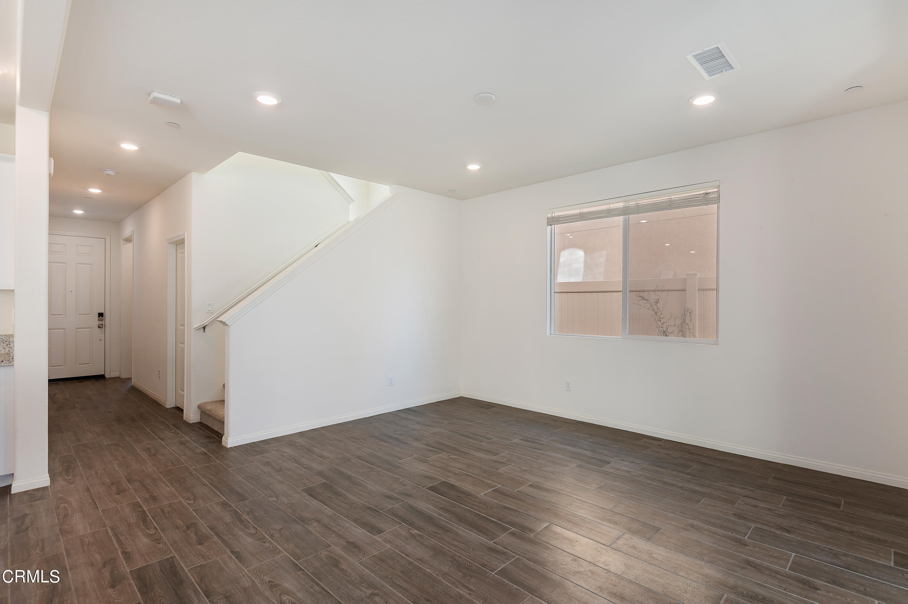 438 Lisbon Place Santa Paula, CA 93060 - Photo 3 of 24 an empty room with wooden floor and windows
