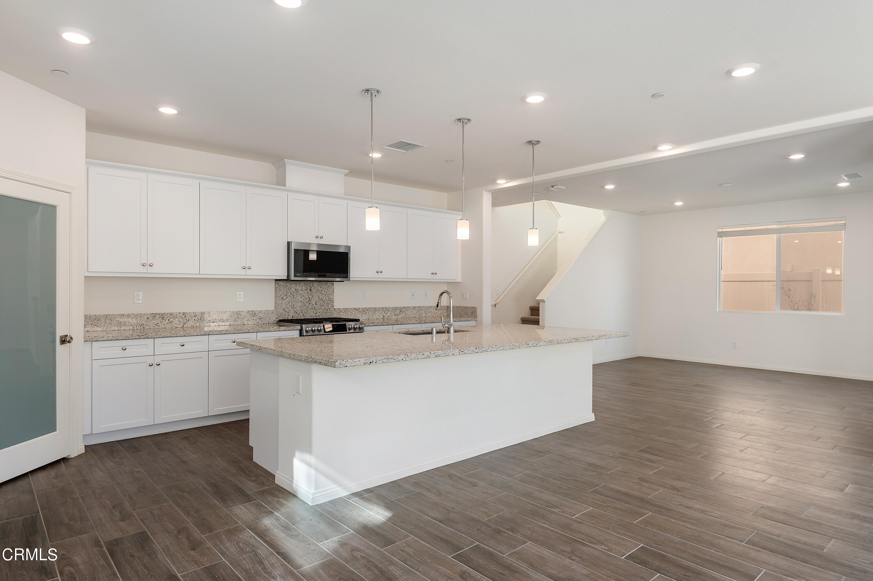 438 Lisbon Place Santa Paula, CA 93060 - Photo 6 of 24 a large kitchen with stainless steel appliances a large counter top a stove a sink and a refrigerator