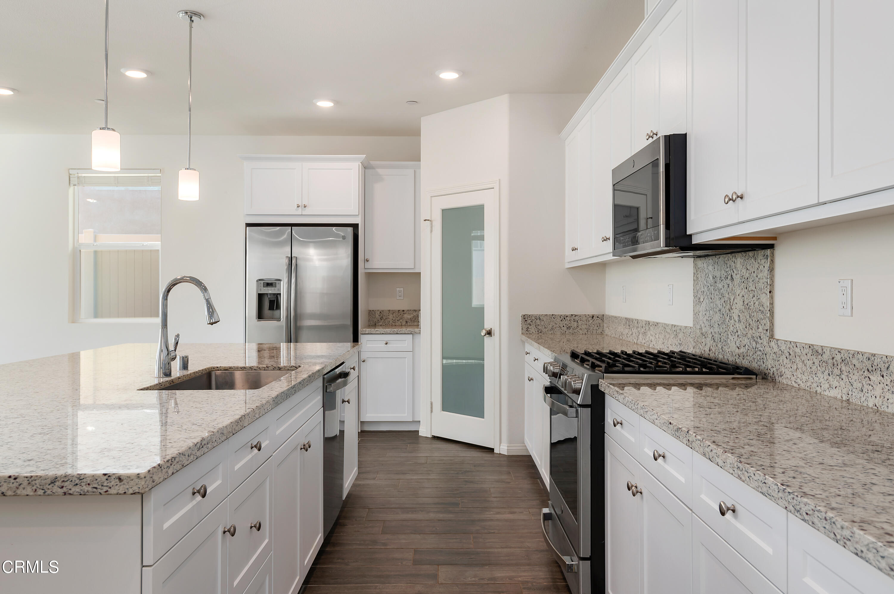 438 Lisbon Place Santa Paula, CA 93060 - Photo 7 of 24 a kitchen with stainless steel appliances granite countertop a sink a stove and a refrigerator