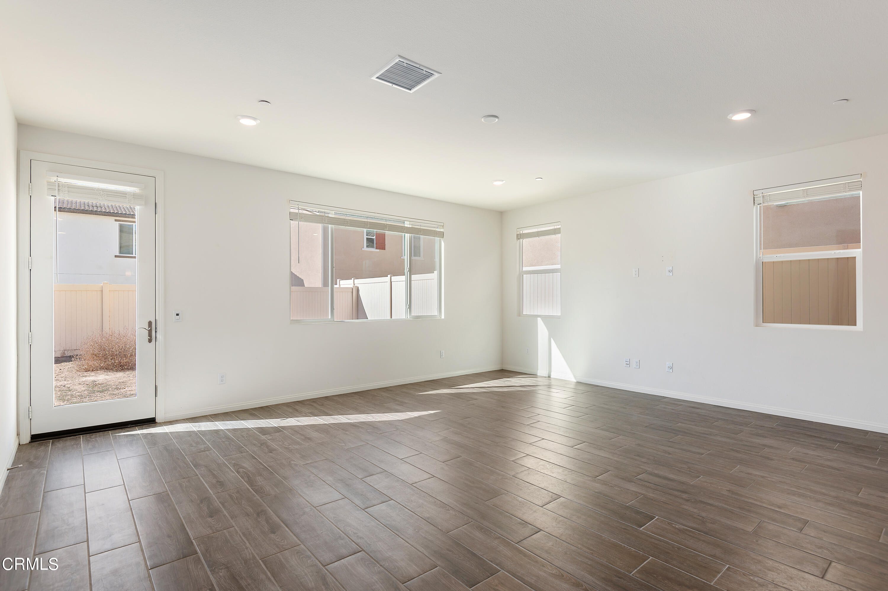 438 Lisbon Place Santa Paula, CA 93060 - Photo 8 of 24 an empty room with wooden floor and window