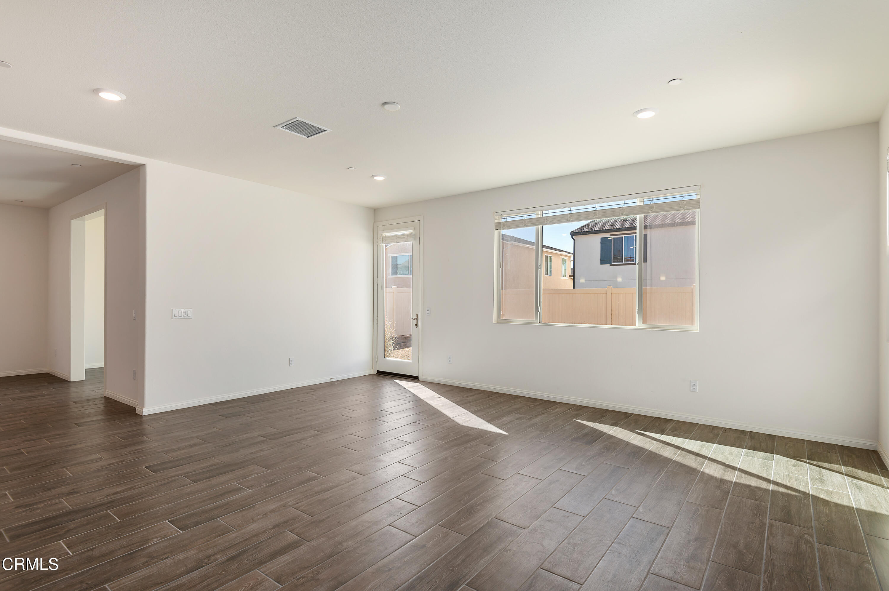 438 Lisbon Place Santa Paula, CA 93060 - Photo 9 of 24 a view of an empty room with wooden floor and a window