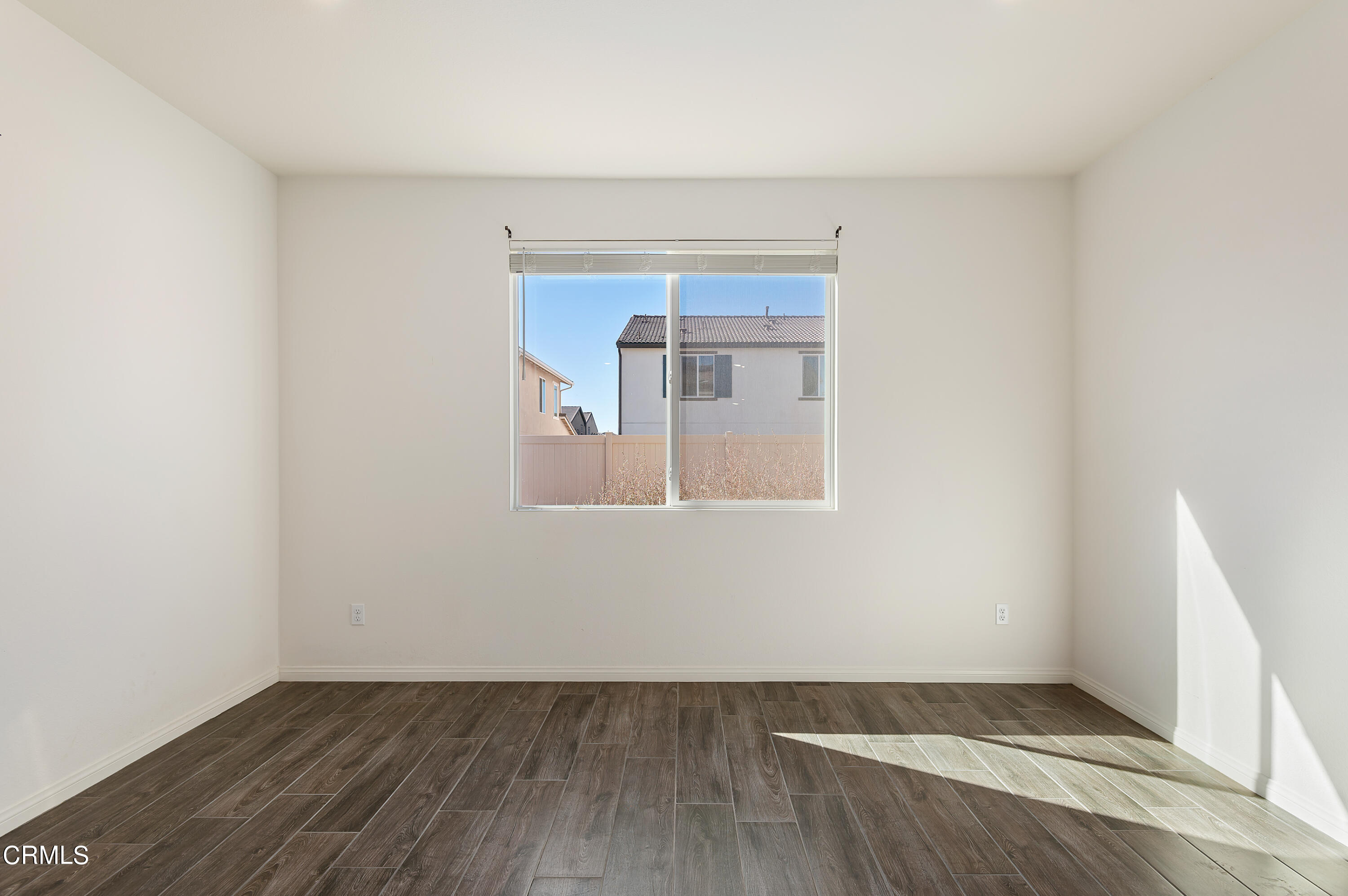 438 Lisbon Place Santa Paula, CA 93060 - Photo 10 of 24 an empty room with wooden floor and windows