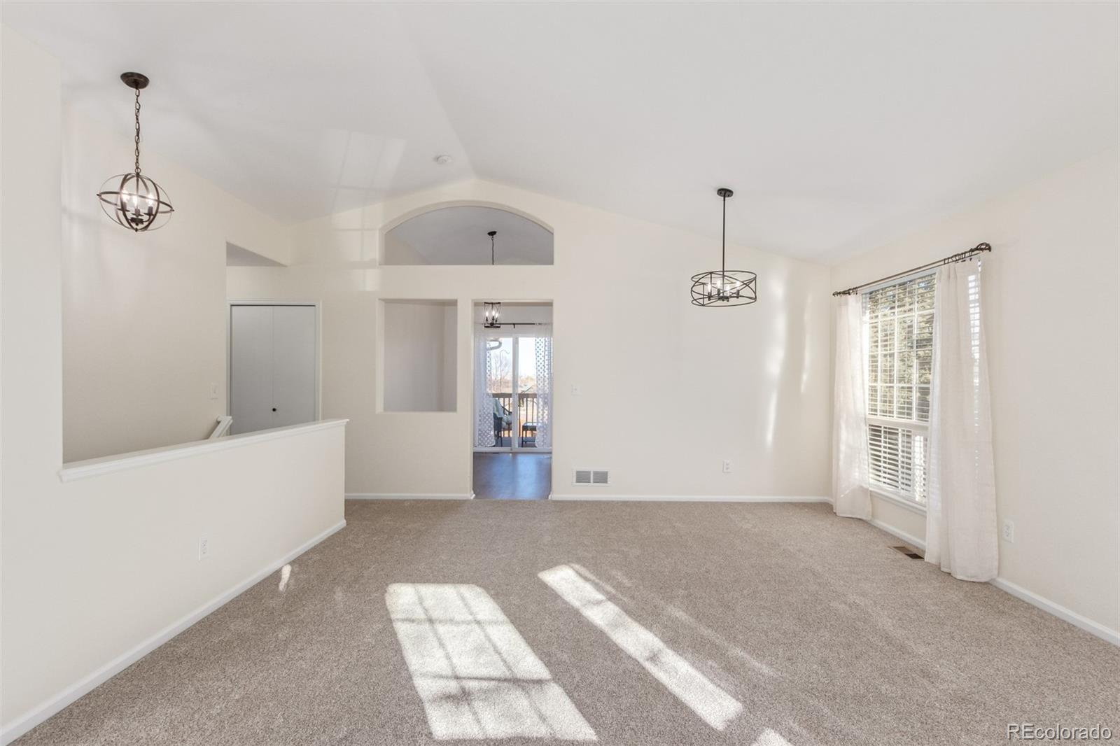 9488 Brook Lane Lone Tree, CO 80124 - Photo 10 of 49 a living room with furniture and a window