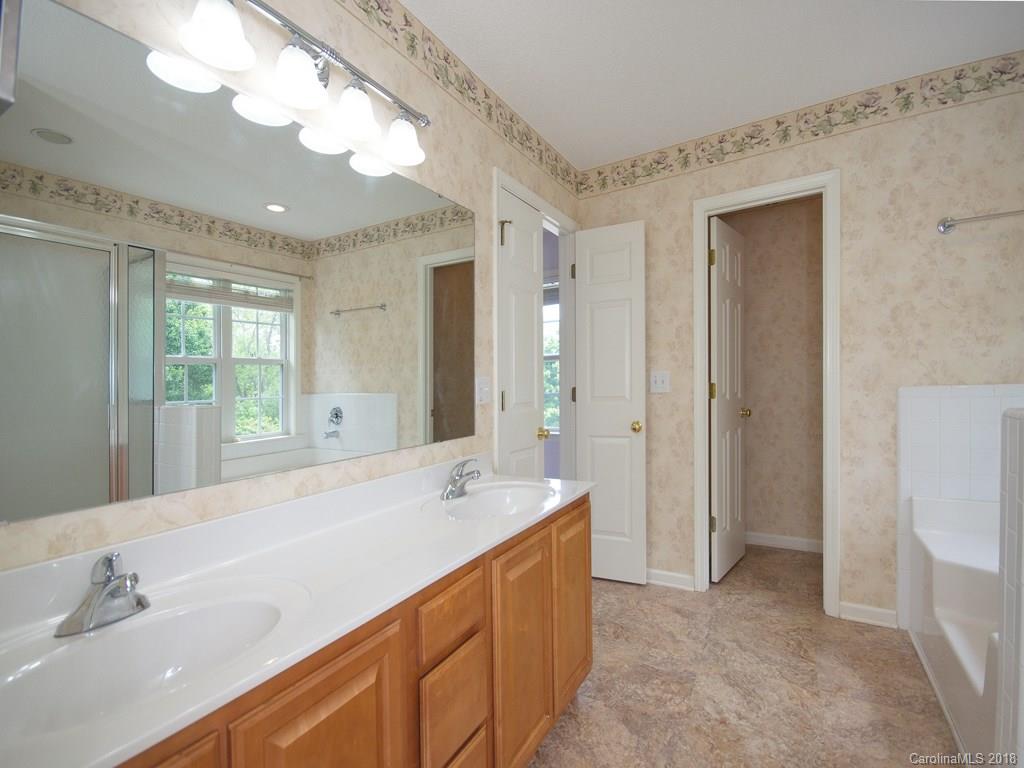 218 Walnut Crest Road, Unit 258 Fletcher, NC 28732 - Photo 15 of 24 a spacious bathroom with a sink a large mirror and a shower