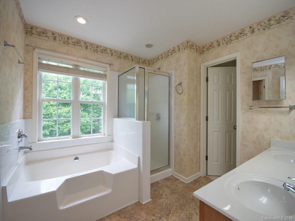 218 Walnut Crest Road, Unit 258 Fletcher, NC 28732 - Photo 16 of 24 a spacious bathroom with a bathtub and a sink