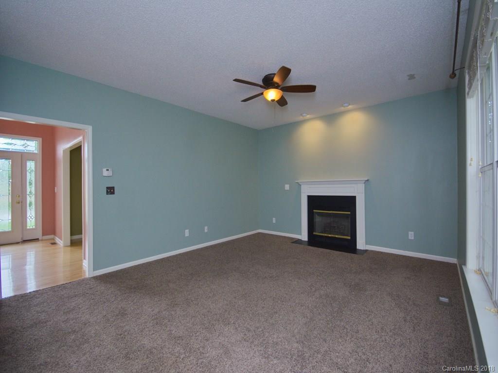 218 Walnut Crest Road, Unit 258 Fletcher, NC 28732 - Photo 5 of 24 an empty room with a fireplace and painted walls