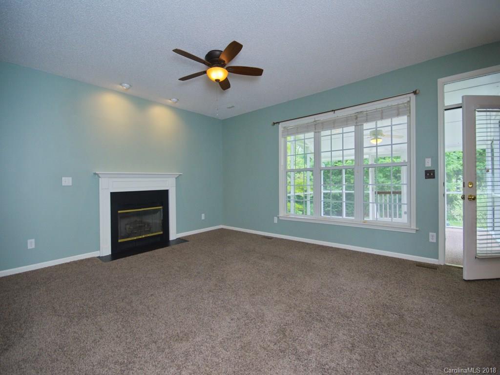 218 Walnut Crest Road, Unit 258 Fletcher, NC 28732 - Photo 6 of 24 an empty room with chandelier fan and windows