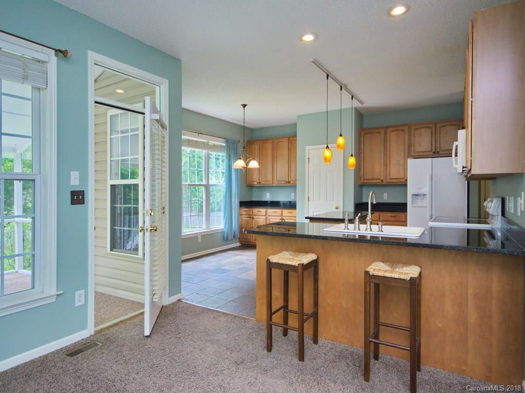 218 Walnut Crest Road, Unit 258 Fletcher, NC 28732 - Photo 7 of 24 a kitchen with sink cabinets and dining table