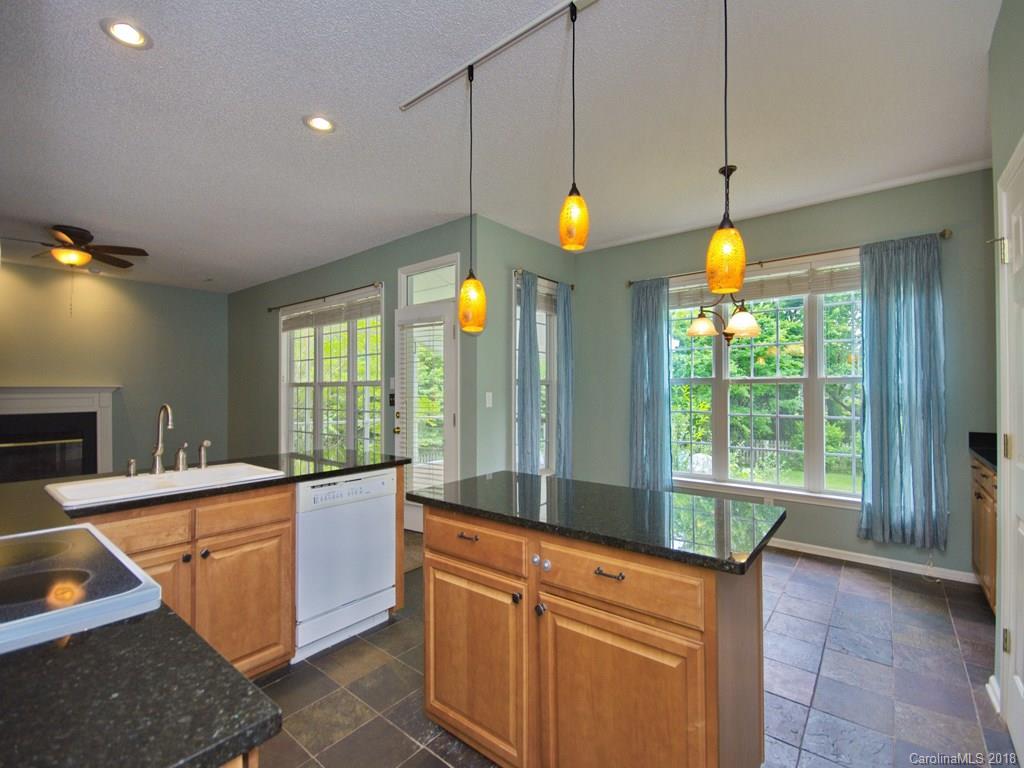 218 Walnut Crest Road, Unit 258 Fletcher, NC 28732 - Photo 9 of 24 a kitchen that has a lot of furniture and a wooden floor