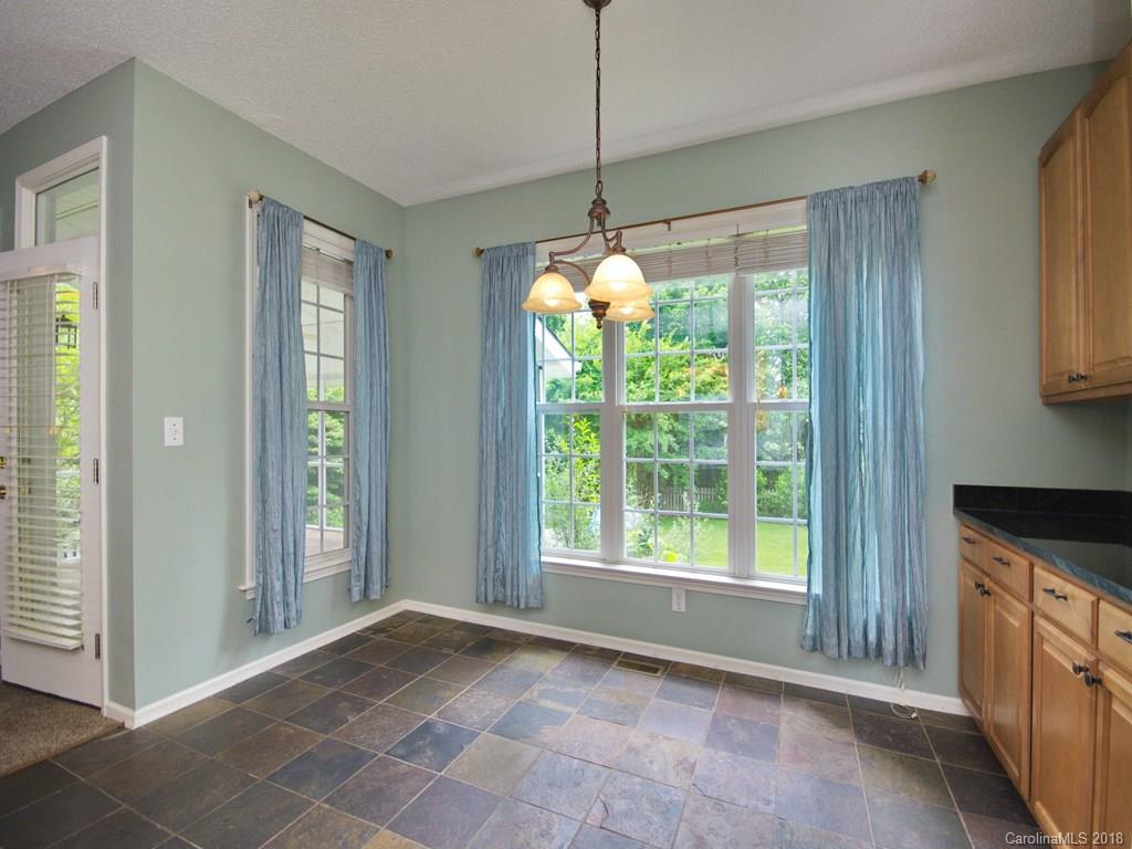 218 Walnut Crest Road, Unit 258 Fletcher, NC 28732 - Photo 10 of 24 a view of an empty room with a window and chandelier