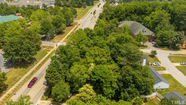 an aerial view of a houses with yard