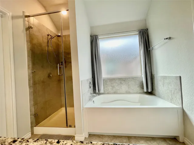 a bathroom with a glass shower door