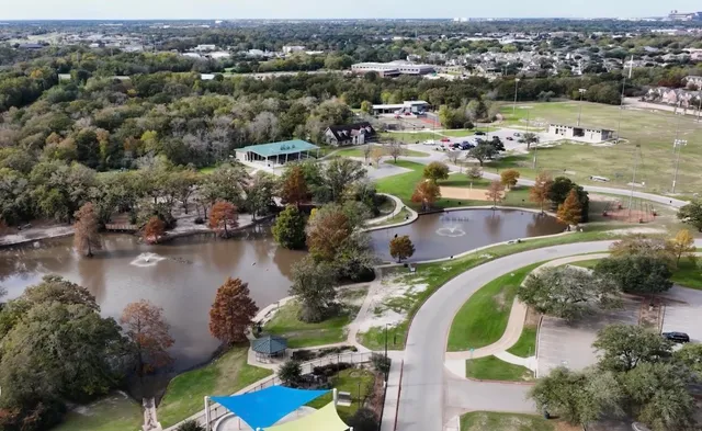 an aerial view of a house with outdoor space and lake view