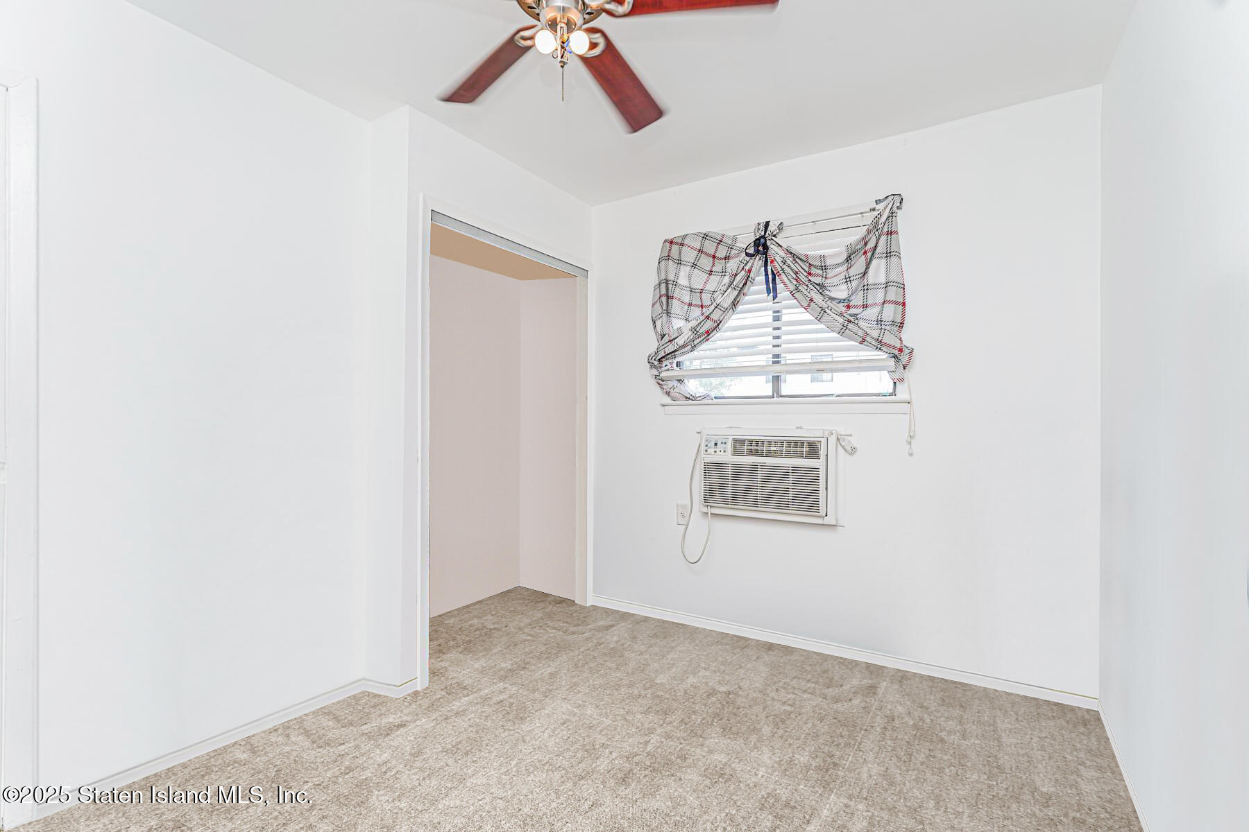 101 Stack Drive, Unit A Staten Island, NY 10312 - Photo 16 of 22 an empty room with windows and fan