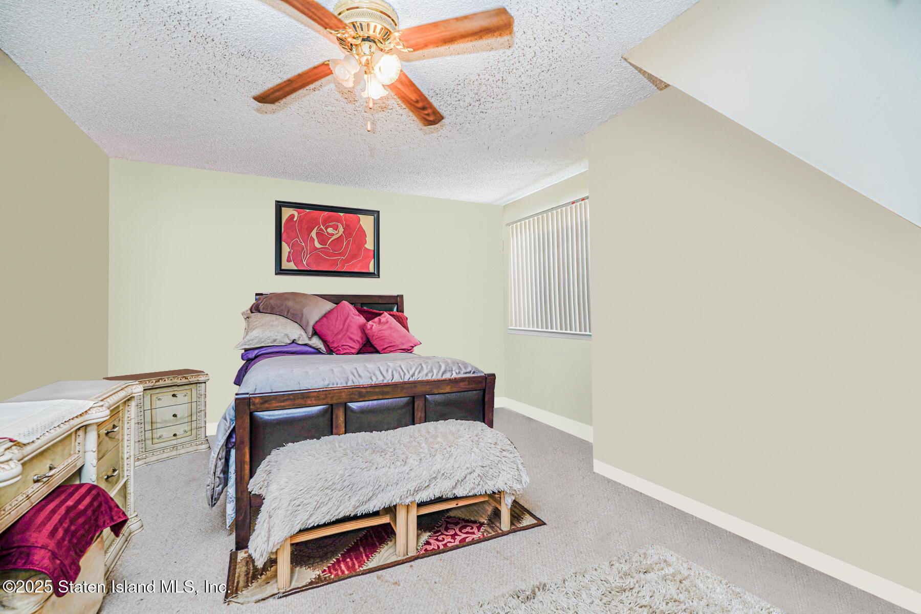 101 Stack Drive, Unit A Staten Island, NY 10312 - Photo 18 of 22 a bedroom with a bed and a chandelier