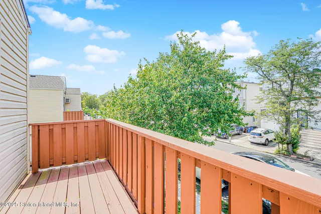a balcony with wooden floor in front of it