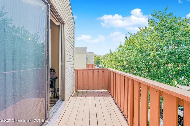 a view of balcony with wooden floor